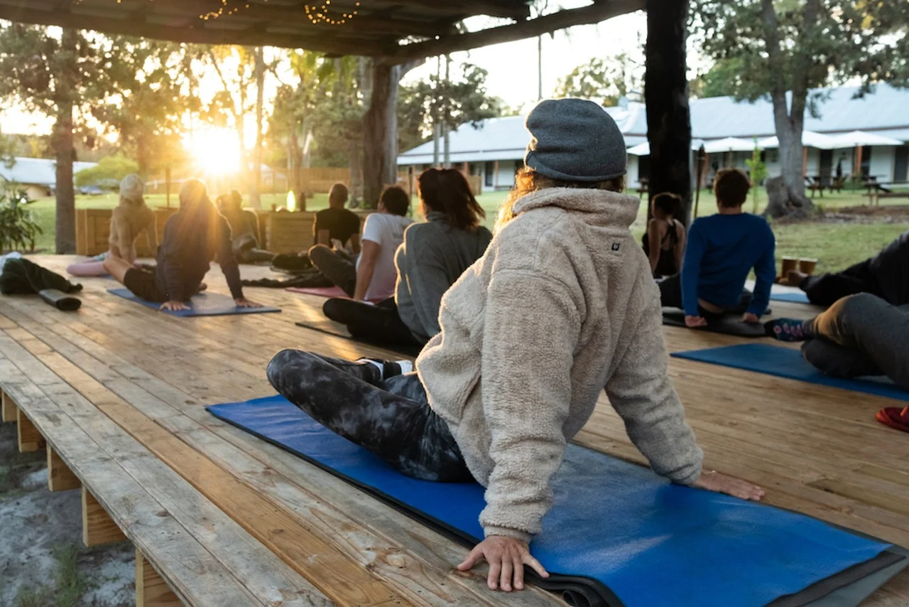 Outdoor sunset yoga session at community retreat